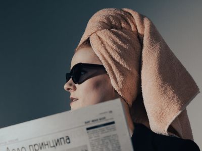 Close-up of a glass of water and a towel on a mat.
